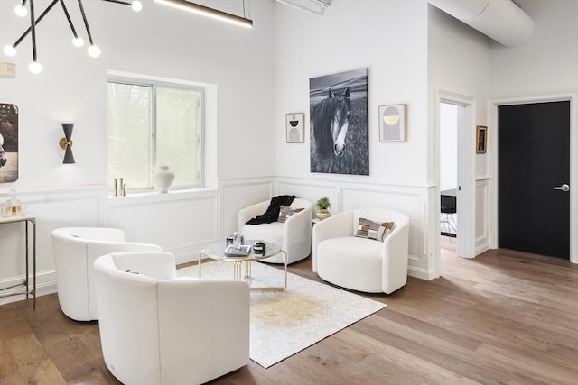 living room featuring wood-type flooring and a chandelier