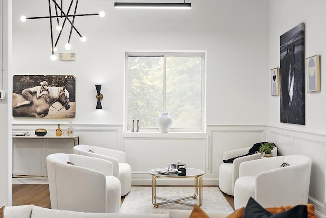 living area featuring light hardwood / wood-style flooring and a notable chandelier