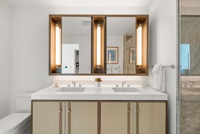 bathroom featuring toilet and vanity