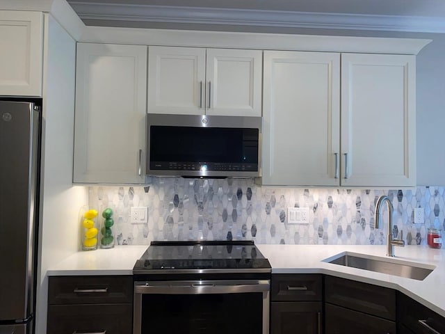 21 Totman St Unit 306, Quincy, MA 02169 - kitchen featuring stainless steel appliances, light countertops, white cabinets, and decorative backsplash