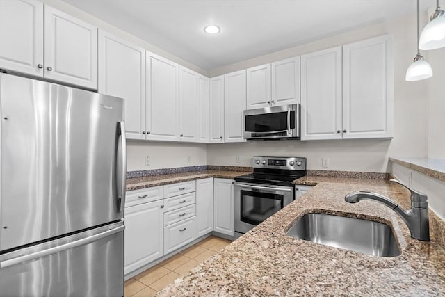 kitchen with white cabinets, appliances with stainless steel finishes, and sink