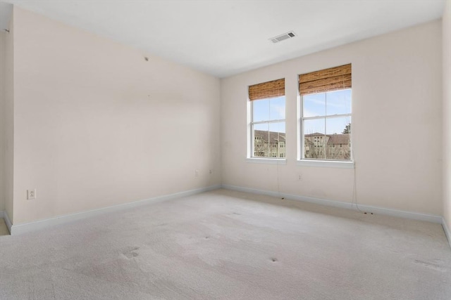 unfurnished room with light colored carpet