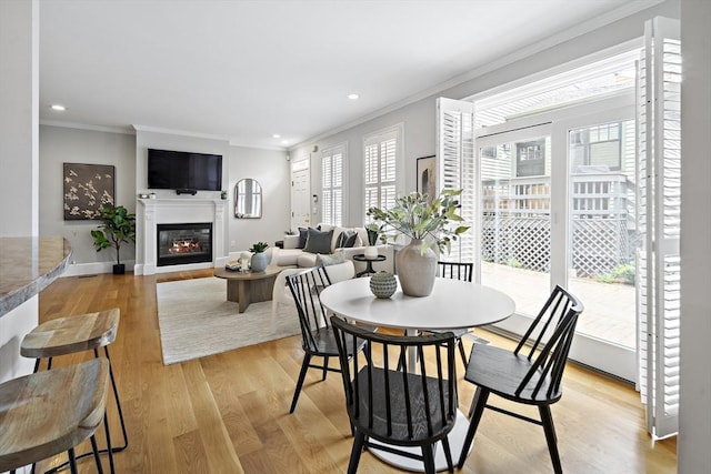 4 Lincoln Pl Unit 4, Boston, MA 02129 - dining area featuring crown molding, light wood finished floors, a glass covered fireplace, recessed lighting, and baseboards