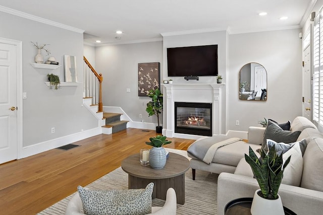 4 Lincoln Pl Unit 4, Boston, MA 02129 - living room with wood finished floors, ornamental molding, a glass covered fireplace, recessed lighting, and baseboards