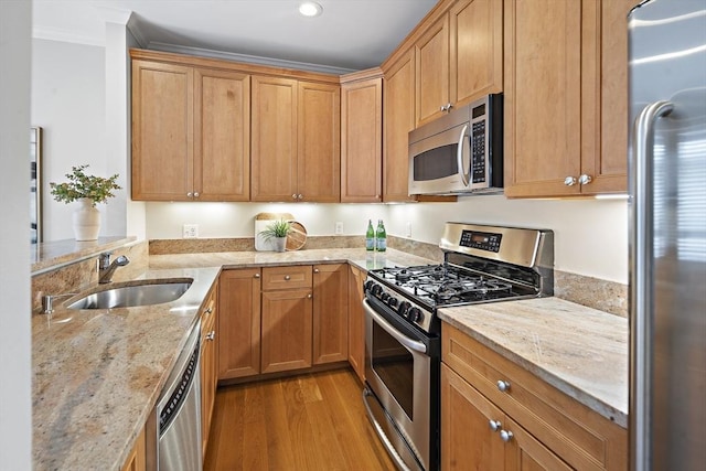 4 Lincoln Pl Unit 4, Boston, MA 02129 - kitchen with stainless steel appliances, a sink, light wood-style flooring, ornamental molding, and light stone counters