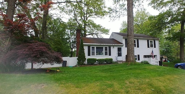 17 Pine Ridge Dr, Ayer, MA 01432 - tri-level home featuring a chimney and an attached garage