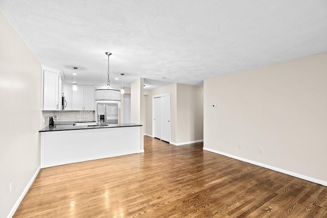 41 Centre Unit 208, Brookline, MA 02446 - unfurnished living room featuring wood finished floors, baseboards, and a sink