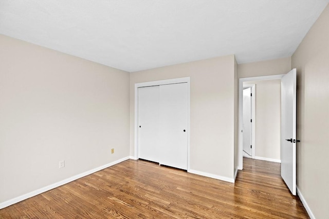 41 Centre Unit 208, Brookline, MA 02446 - unfurnished bedroom featuring wood finished floors, baseboards, and a closet