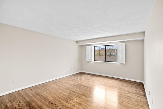 41 Centre Unit 208, Brookline, MA 02446 - empty room featuring wood finished floors, baseboards, and a textured ceiling