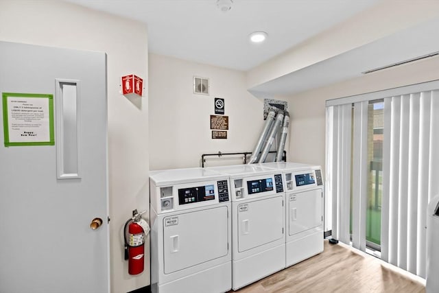 41 Centre Unit 208, Brookline, MA 02446 - communal laundry room with independent washer and dryer and light wood-type flooring