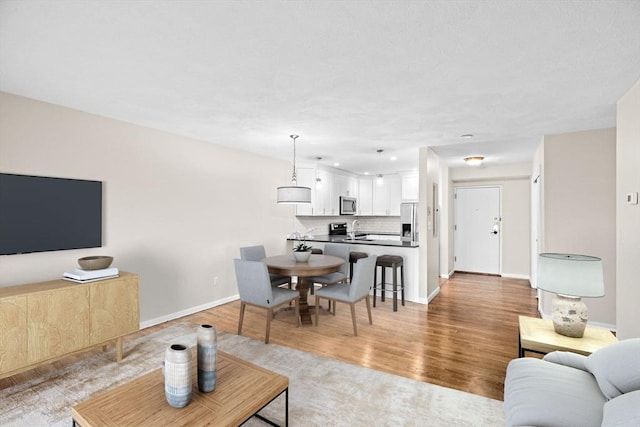 41 Centre Unit 208, Brookline, MA 02446 - living area with light wood-style flooring and baseboards
