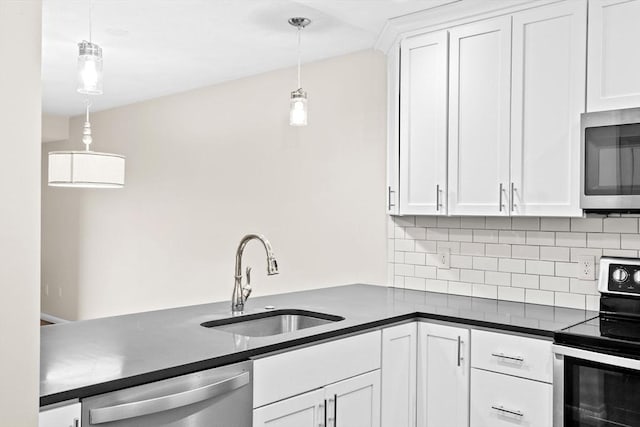 41 Centre Unit 208, Brookline, MA 02446 - kitchen featuring appliances with stainless steel finishes, a sink, dark countertops, backsplash, and white cabinetry