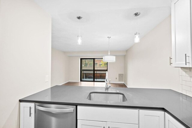41 Centre Unit 208, Brookline, MA 02446 - kitchen featuring stainless steel dishwasher, a sink, dark countertops, and white cabinetry