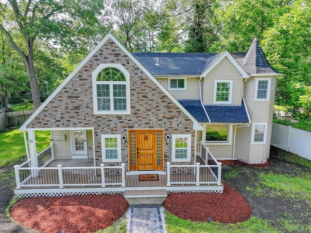 21 Beechwood Ave, Pembroke, MA 02359 - view of front of home featuring covered porch, stone siding, a shingled roof, and view of wooded area