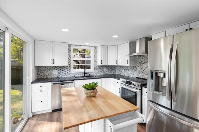 21 Beechwood Ave, Pembroke, MA 02359 - kitchen with appliances with stainless steel finishes, wall chimney range hood, healthy amount of natural light, wood finished floors, and recessed lighting