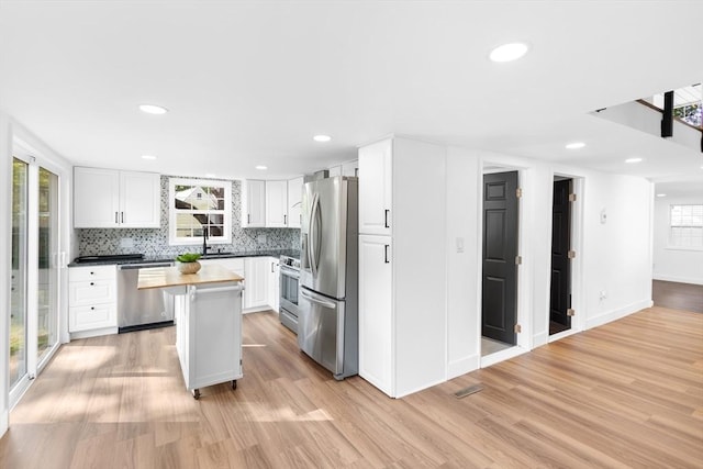 21 Beechwood Ave, Pembroke, MA 02359 - kitchen featuring stainless steel appliances, plenty of natural light, light wood finished floors, white cabinetry, and recessed lighting