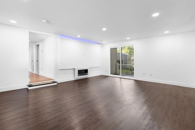 21 Beechwood Ave, Pembroke, MA 02359 - unfurnished living room featuring dark wood-type flooring, recessed lighting, and a fireplace