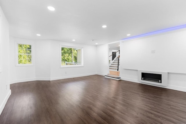 21 Beechwood Ave, Pembroke, MA 02359 - unfurnished living room featuring dark wood-style flooring, stairway, recessed lighting, and a fireplace