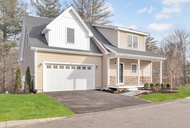 view of front of home with aphalt driveway, stone siding, a porch, roof with shingles, and a front yard