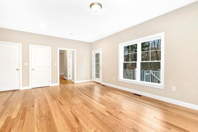 unfurnished bedroom featuring visible vents, baseboards, and light wood-style floors