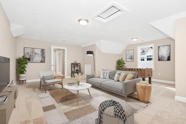 living room featuring baseboards and light carpet