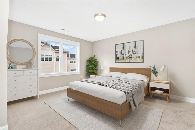 bedroom with carpet flooring, visible vents, and baseboards