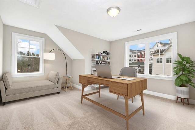 carpeted home office with baseboards and vaulted ceiling