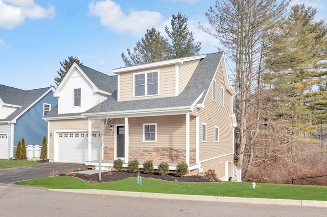 view of front of property featuring a garage, stone siding, driveway, and roof with shingles