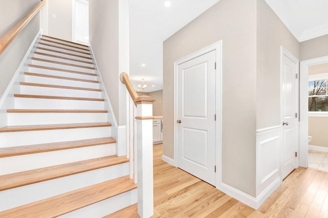 stairs with baseboards and wood finished floors