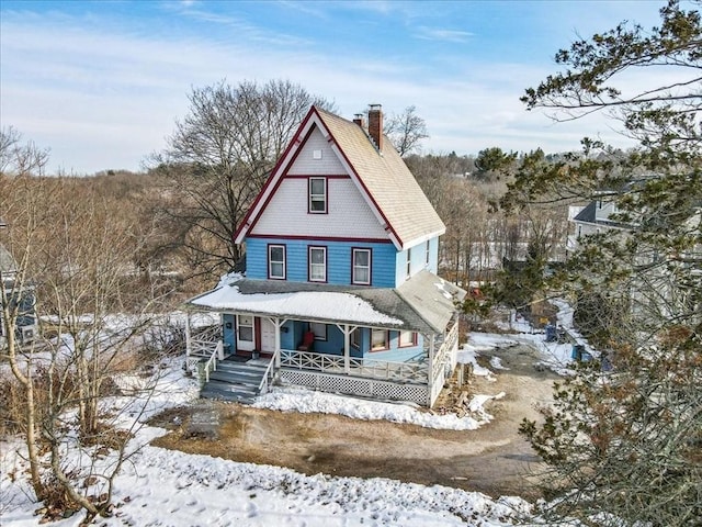 victorian house with covered porch and a chimney