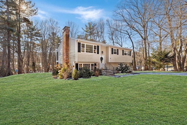 raised ranch with a front yard