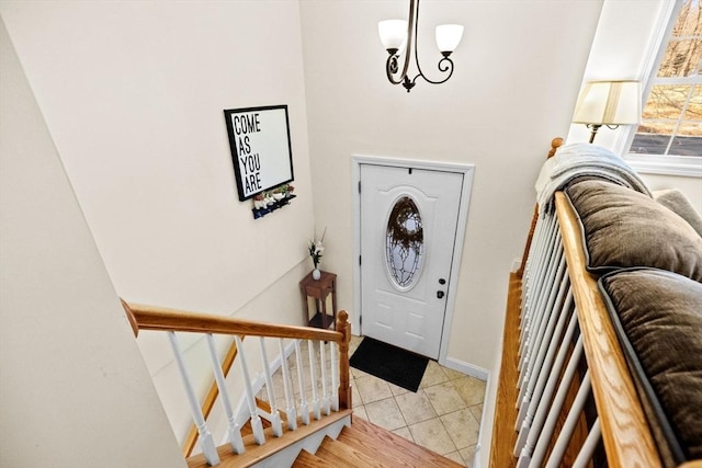 foyer entrance featuring a chandelier and light tile patterned floors