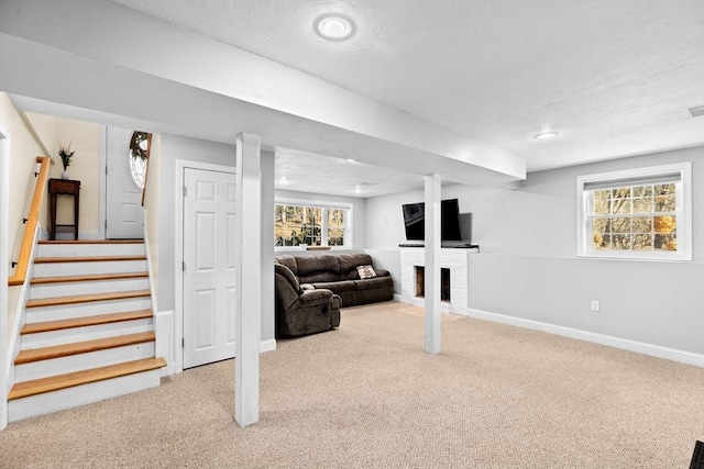 basement featuring a fireplace and carpet floors