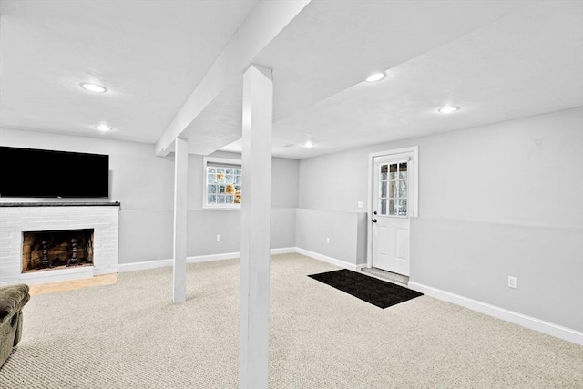 basement with carpet and a fireplace