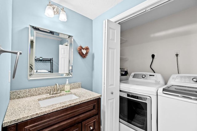 laundry area with sink and washing machine and dryer