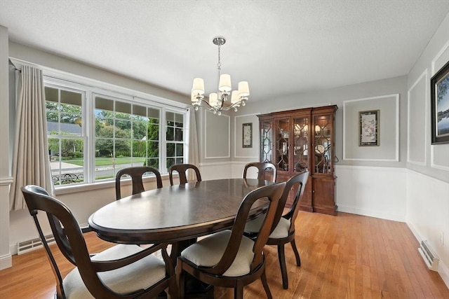 11 Rachael Ter, Westfield, MA 01085 - dining area with a chandelier, light wood-style flooring, and a textured ceiling