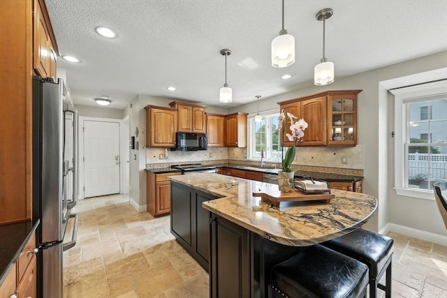 11 Rachael Ter, Westfield, MA 01085 - kitchen with appliances with stainless steel finishes, stone tile floors, brown cabinets, recessed lighting, and a textured ceiling