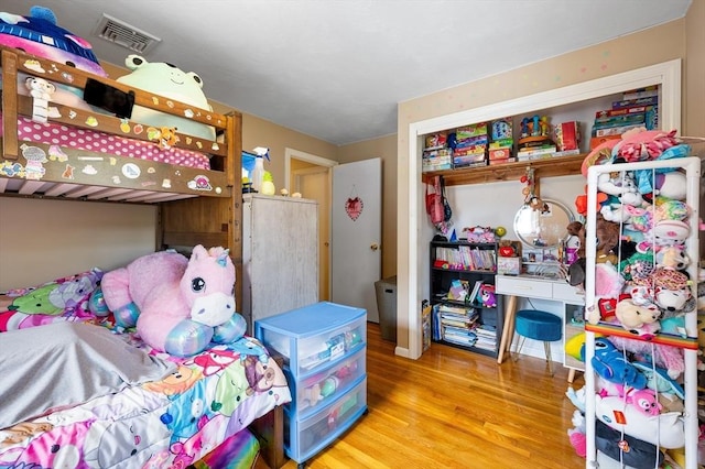 bedroom featuring wood finished floors and a closet