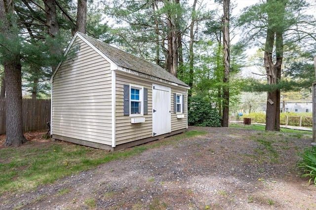 view of outbuilding featuring an outbuilding and fence