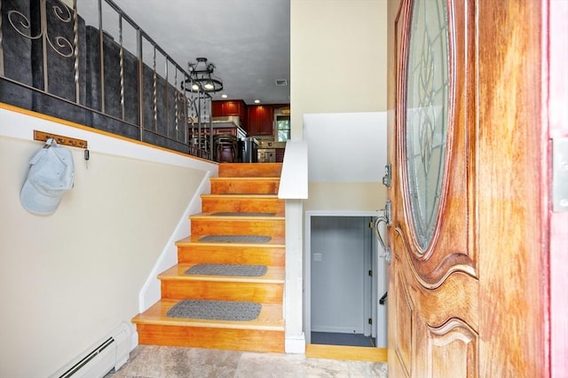 stairway featuring a baseboard radiator