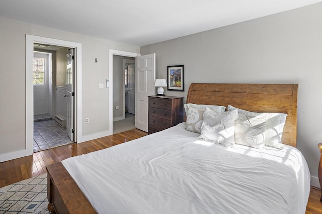 8 School House Vlg, Oak Bluffs, MA 02557 - bedroom with hardwood / wood-style flooring, a baseboard radiator, baseboards, and ensuite bath