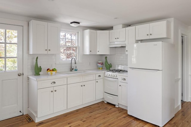 8 School House Vlg, Oak Bluffs, MA 02557 - kitchen featuring white appliances, a sink, under cabinet range hood, light countertops, and white cabinets