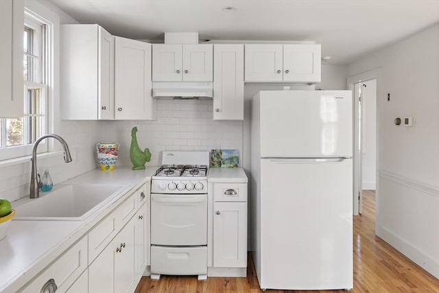 8 School House Vlg, Oak Bluffs, MA 02557 - kitchen with white appliances, extractor fan, a sink, backsplash, and white cabinets