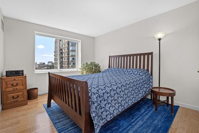 bedroom featuring baseboards and wood finished floors