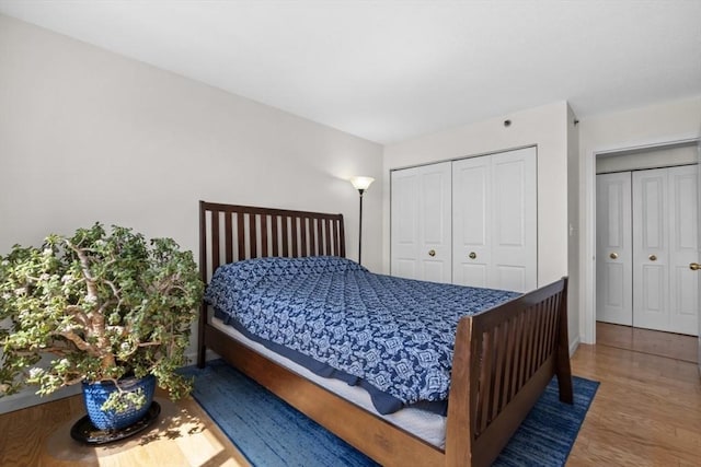 bedroom featuring a closet, baseboards, and wood finished floors