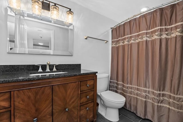 bathroom featuring toilet, tile patterned floors, and vanity