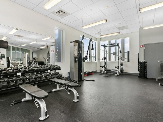 gym featuring a paneled ceiling and visible vents