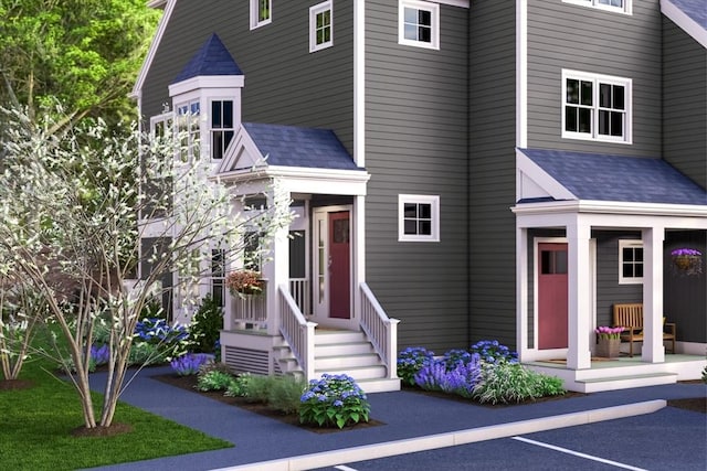 91 Miter Dr Unit 2-2, Plymouth, MA 02360 - view of front of property with uncovered parking, a porch, and roof with shingles