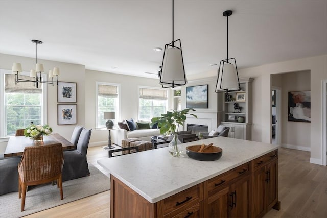 91 Miter Dr Unit 2-2, Plymouth, MA 02360 - kitchen with open floor plan, hanging light fixtures, an inviting chandelier, and light wood-type flooring