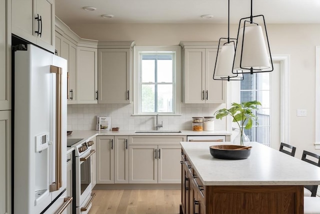 91 Miter Dr Unit 2-2, Plymouth, MA 02360 - kitchen with white appliances, light wood-style flooring, decorative backsplash, and a sink